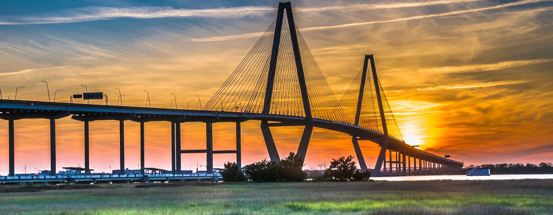 a bridge with a sunset in the background