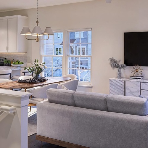 a living room with a tv, table, chairs and couch