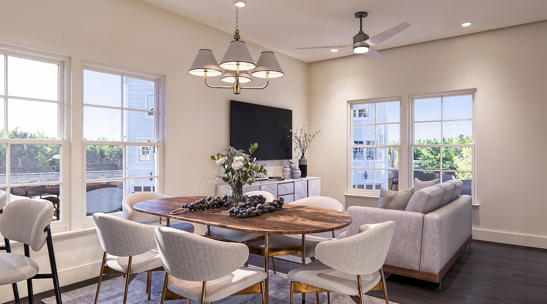 a living room with a couch, table, chairs and a tv