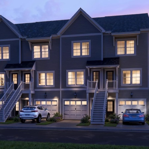 a house with a staircase and cars parked in front
